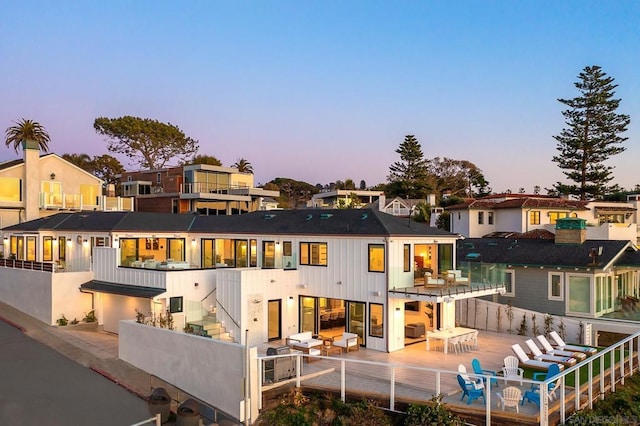 back house at dusk with a patio