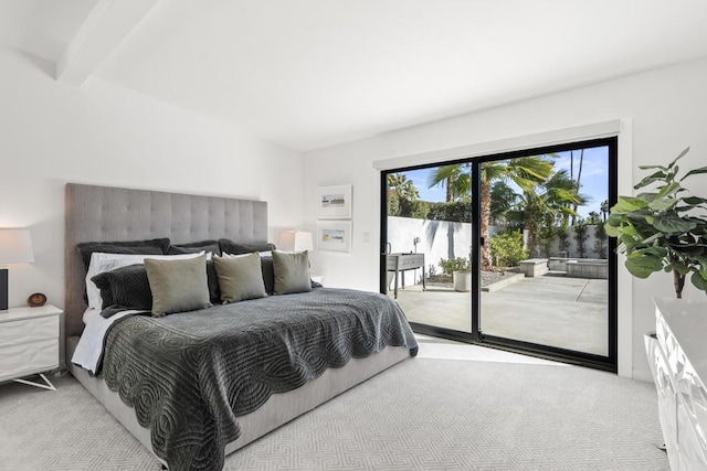 carpeted bedroom with access to exterior and beam ceiling