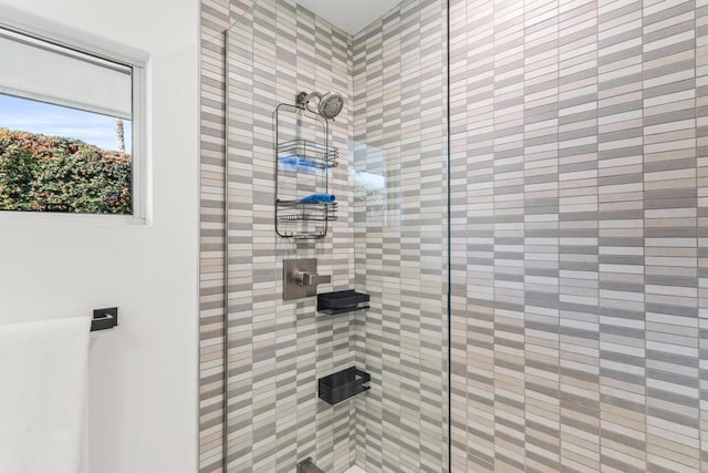 bathroom with a tile shower