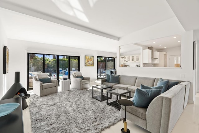 living room with lofted ceiling with beams and a chandelier