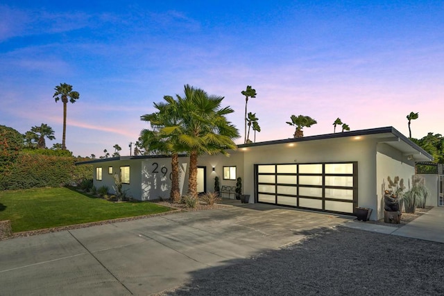 view of front of property featuring a yard and a garage