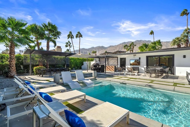 view of swimming pool with a patio, a pergola, and a mountain view