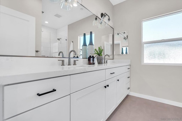 bathroom featuring a shower with door and vanity