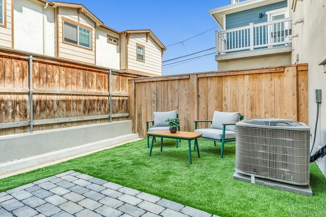 view of patio with a balcony and central AC