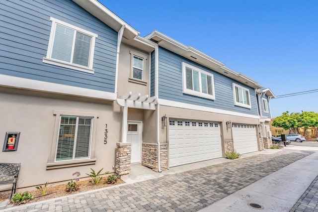 townhome / multi-family property featuring a garage