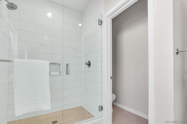 bathroom featuring toilet and walk in shower