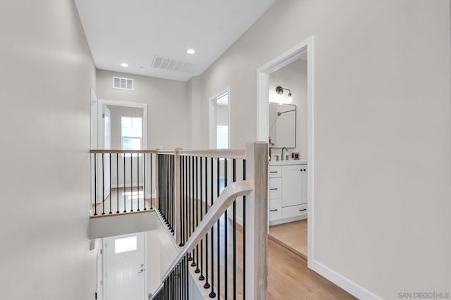 hallway featuring light hardwood / wood-style floors and sink