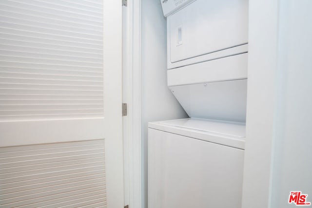 laundry area with stacked washer and clothes dryer