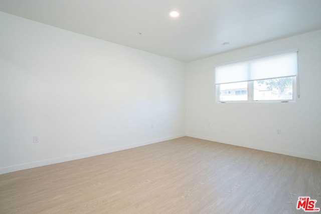 unfurnished room with light hardwood / wood-style floors