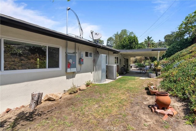 view of yard featuring central air condition unit and a patio