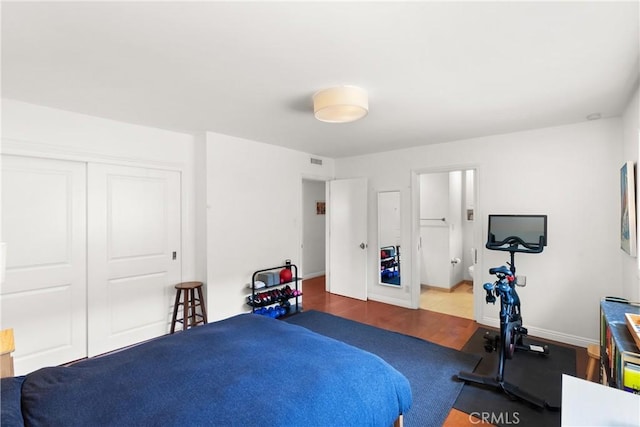 bedroom featuring a closet and dark hardwood / wood-style floors