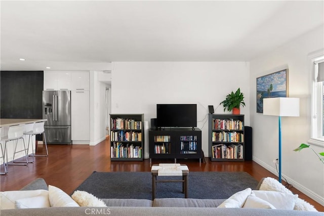 living room with dark hardwood / wood-style flooring