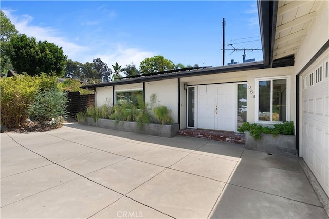 entrance to property featuring a patio