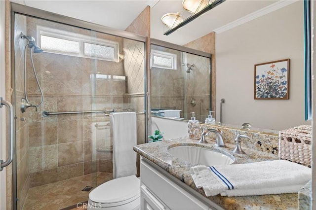 bathroom with toilet, a shower with door, vanity, and crown molding