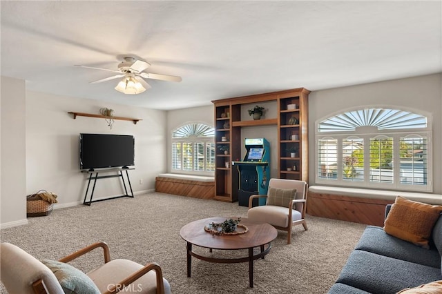 living room featuring ceiling fan, light carpet, and plenty of natural light