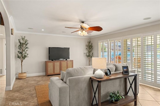 tiled living room with ornamental molding and ceiling fan