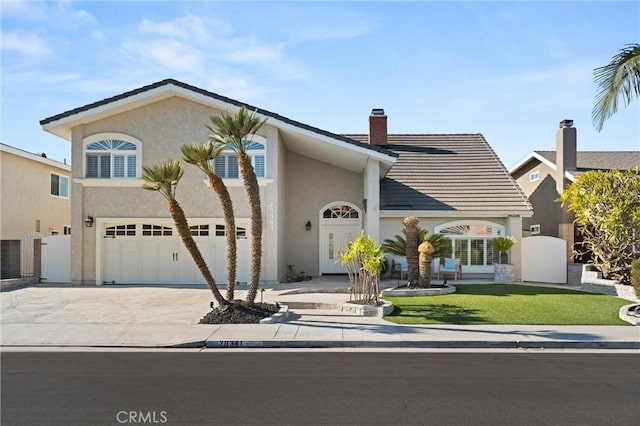 view of front of home featuring a front yard and a garage