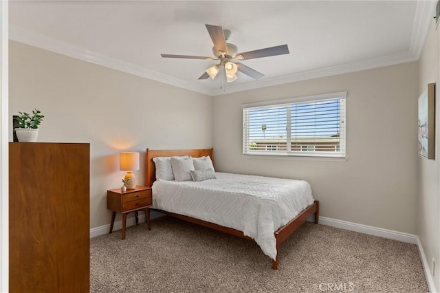 carpeted bedroom featuring ceiling fan and crown molding