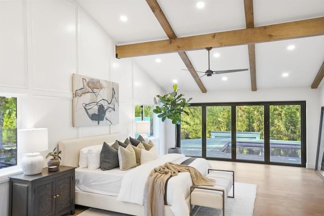 bedroom featuring vaulted ceiling with beams, access to outside, and light hardwood / wood-style floors