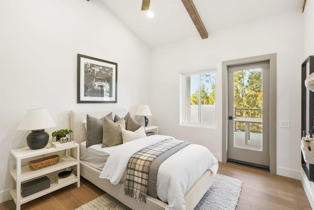 bedroom with vaulted ceiling with beams, hardwood / wood-style floors, and ceiling fan