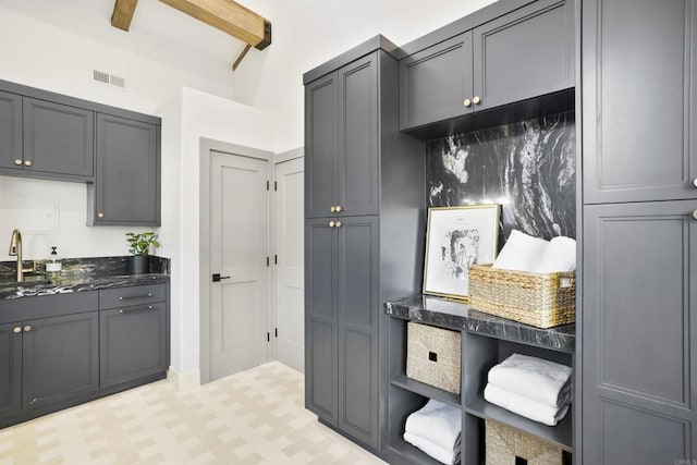 mudroom with sink and beam ceiling