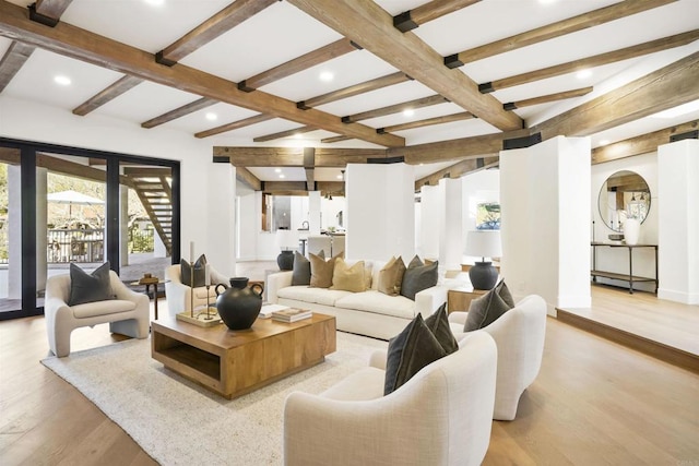 living room featuring beamed ceiling and light wood-type flooring