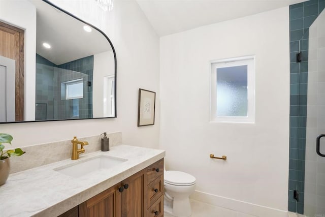 bathroom featuring vanity, tile patterned flooring, a shower with door, and toilet