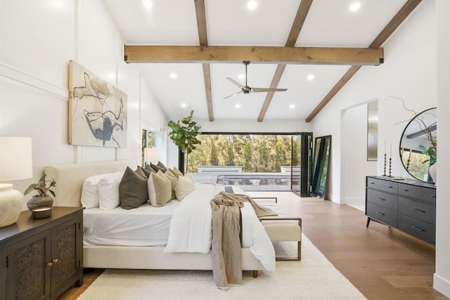 bedroom featuring lofted ceiling with beams and light hardwood / wood-style floors