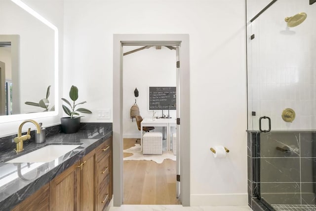 bathroom featuring vanity, hardwood / wood-style floors, and walk in shower