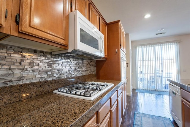 kitchen with backsplash and white appliances