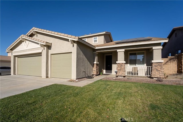 view of front facade with covered porch, a garage, solar panels, and a front lawn