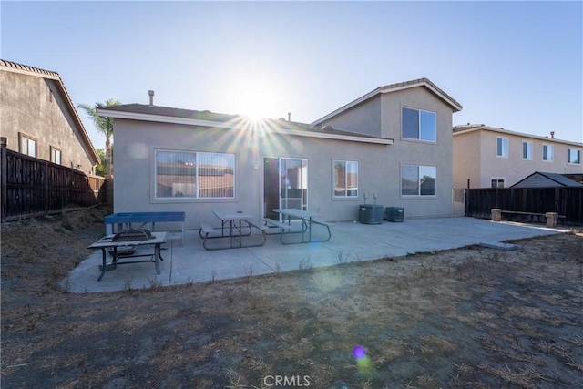 rear view of property featuring a patio area and cooling unit