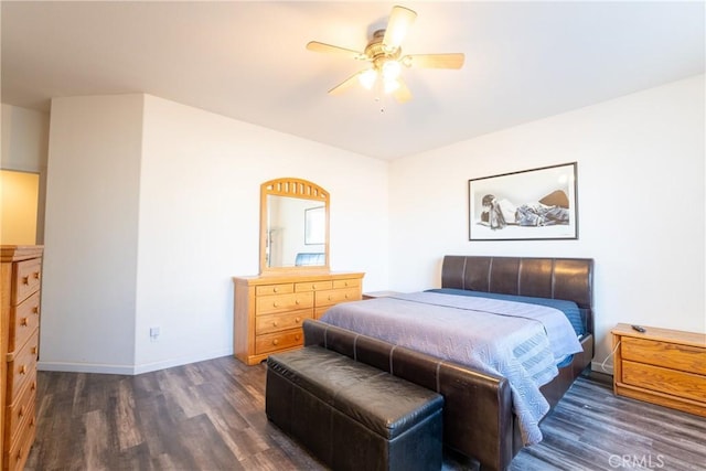 bedroom with ceiling fan and dark hardwood / wood-style flooring