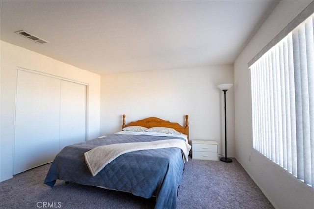 carpeted bedroom with a closet