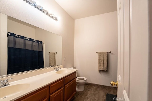 bathroom with toilet, a shower with curtain, wood-type flooring, and vanity