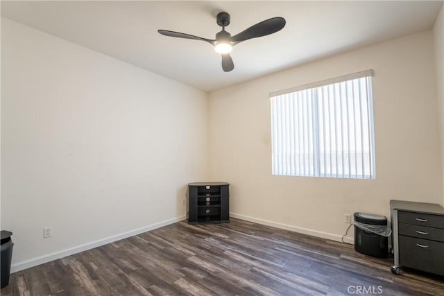 spare room featuring ceiling fan and dark hardwood / wood-style floors