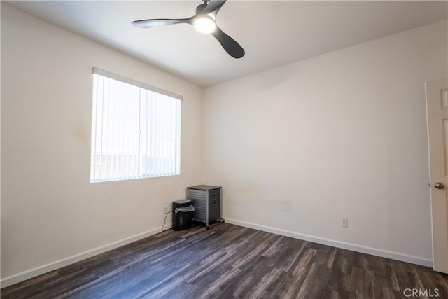 empty room featuring ceiling fan and dark hardwood / wood-style flooring