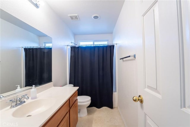 full bathroom featuring toilet, vanity, tile patterned flooring, and shower / tub combo