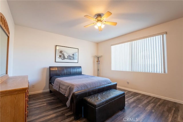 bedroom with ceiling fan and dark hardwood / wood-style flooring