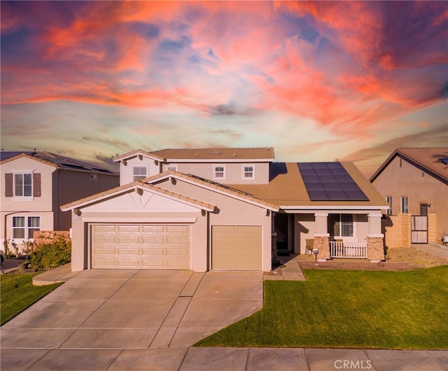 view of front facade featuring a yard, covered porch, and solar panels