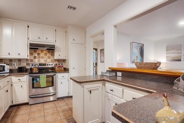 kitchen with stainless steel electric stove, kitchen peninsula, and white cabinets