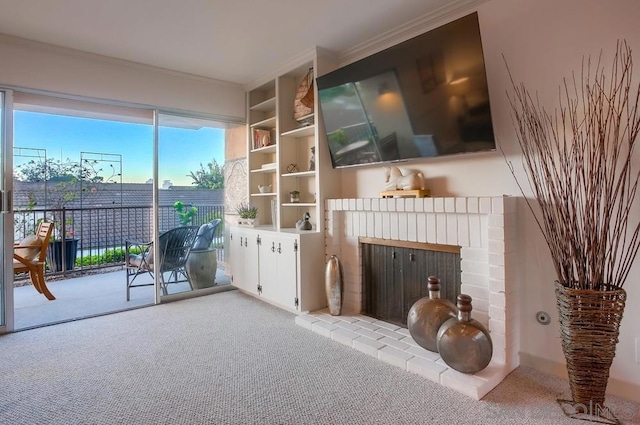 living room featuring crown molding, light colored carpet, and a fireplace