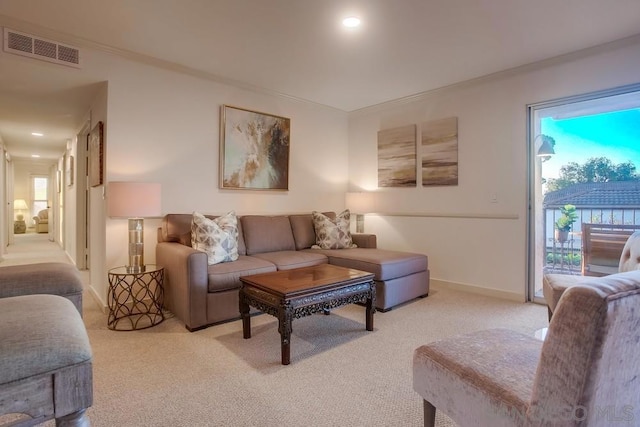 living room featuring crown molding and light carpet