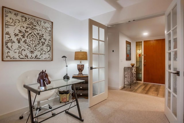 carpeted home office with french doors