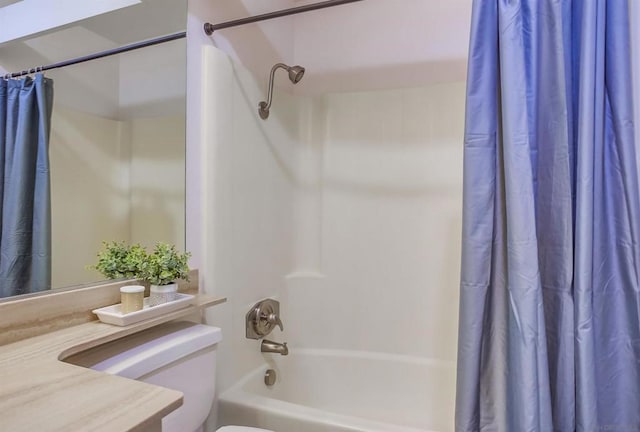 bathroom featuring shower / bathtub combination with curtain and toilet