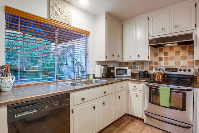 kitchen with sink, black dishwasher, white cabinets, light tile patterned flooring, and stainless steel range with electric cooktop