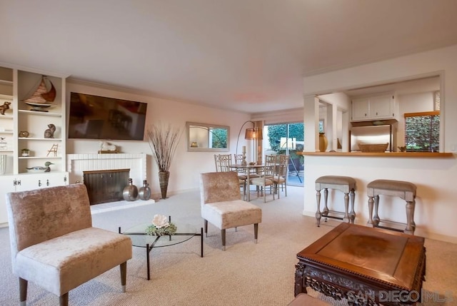 living room featuring light colored carpet and a fireplace