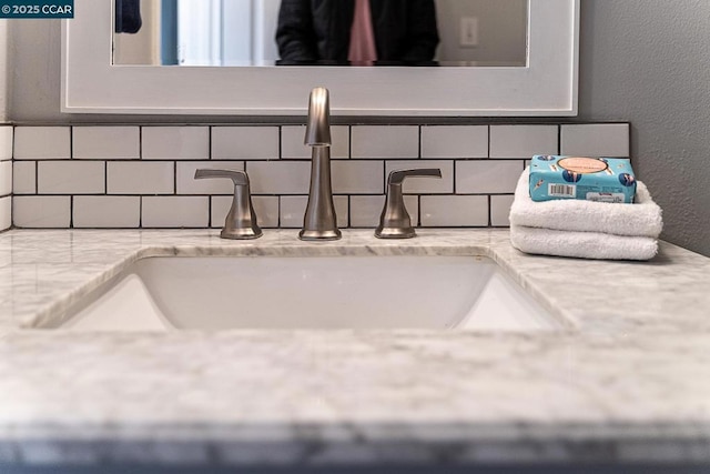 interior details featuring backsplash and vanity