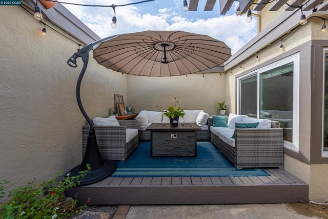 view of patio featuring a wooden deck and an outdoor living space