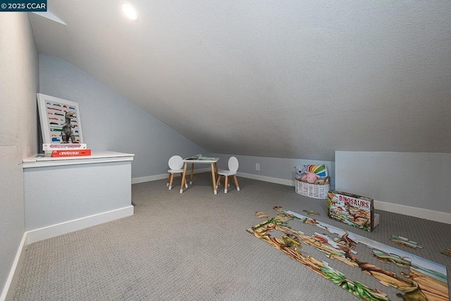 playroom featuring vaulted ceiling and carpet flooring